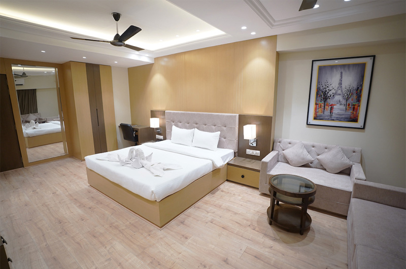 King-size bed in a suite at Hotel Suffa International, Indore